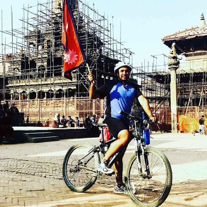 Cycling with Nepal flag in Kathmandu