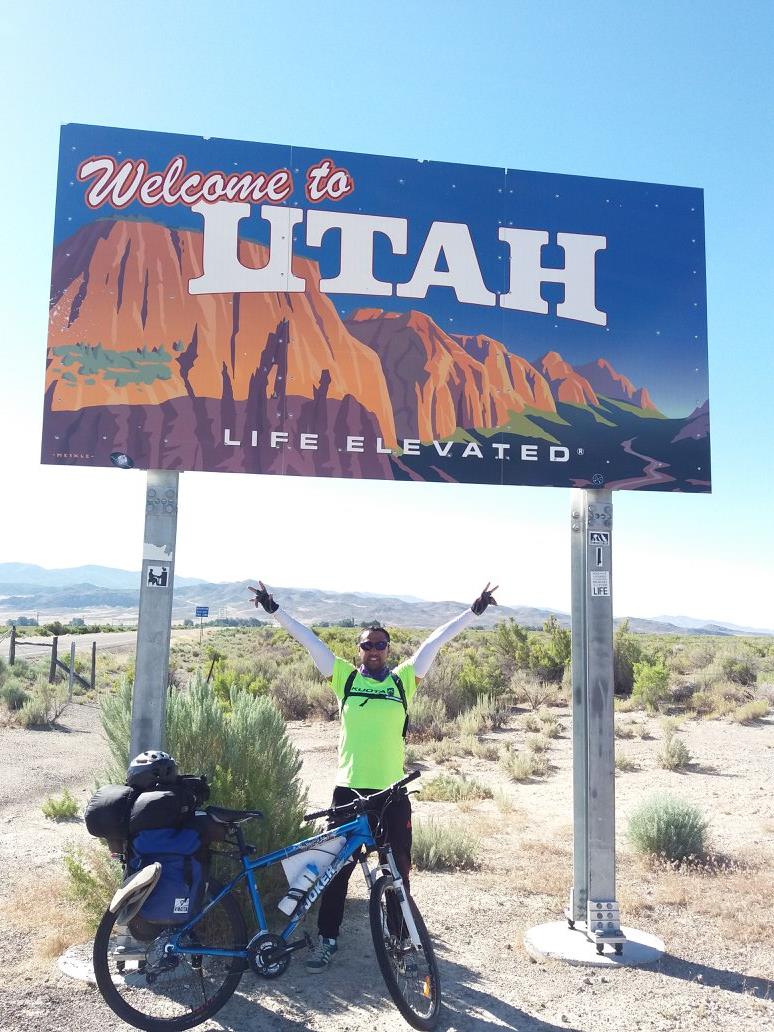 Cycling at Welcome to Utah sign